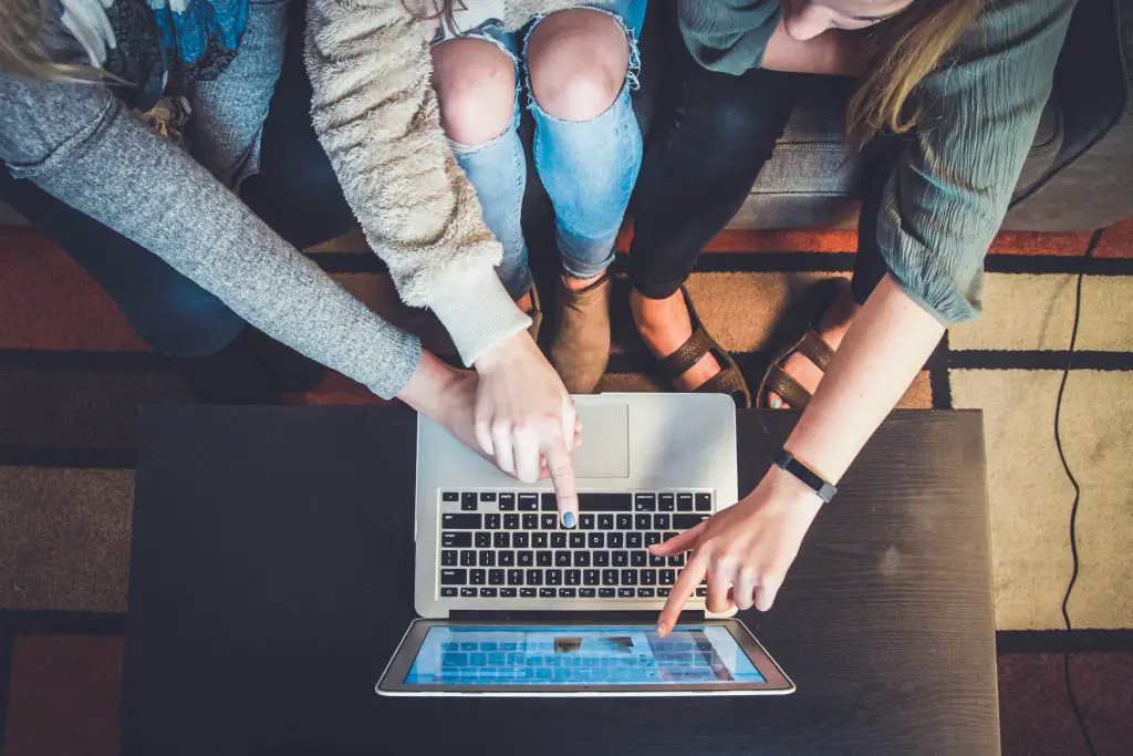 friends searching for apartment on computer